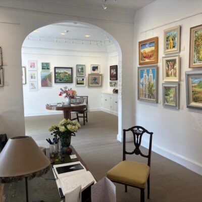 Through arch to my two oil paintings in the Summer Exhibition Fosse Gallery Stow on the Wold
